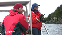 Biologists Lauri Jemison and Jamie King watch an entangled sea lion at the Benjamin Island haulout near Juneau